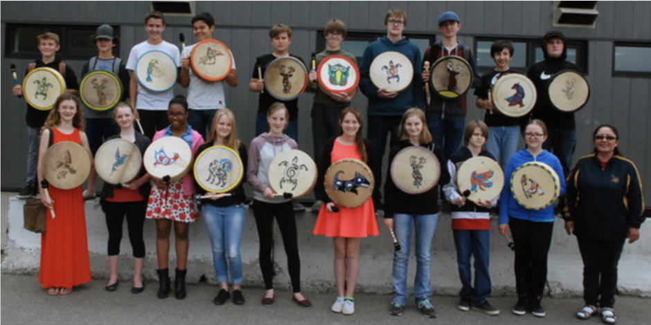 Children showing the drums they made