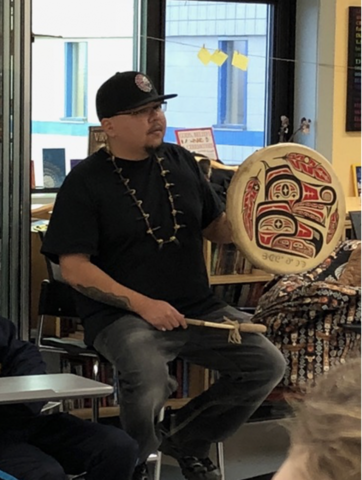 Clayton Gauthier holding a traditional drum.
